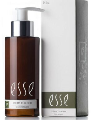 A brown pump bottle labeled "Esse Cream Cleanser" stands beside its matching cream and green box. The sleek, minimalist design displays the brand name in white along with a small logo on the packaging. The bottle contains 3.4 fl oz of product.