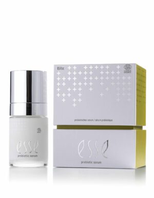 A bottle of Esse Probiotic Serum with a silver cap sits beside its matching white box, which features silver and gold accents and displays the product name.