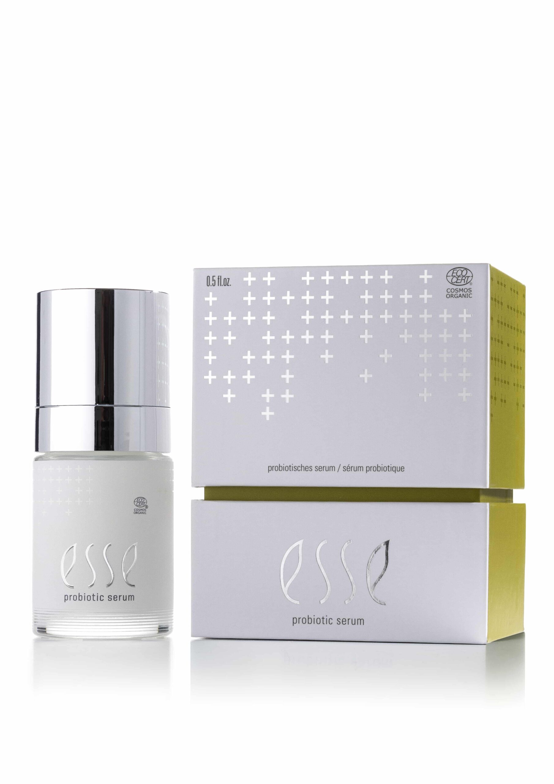 A bottle of Esse Probiotic Serum with a silver cap sits beside its matching white box, which features silver and gold accents and displays the product name.